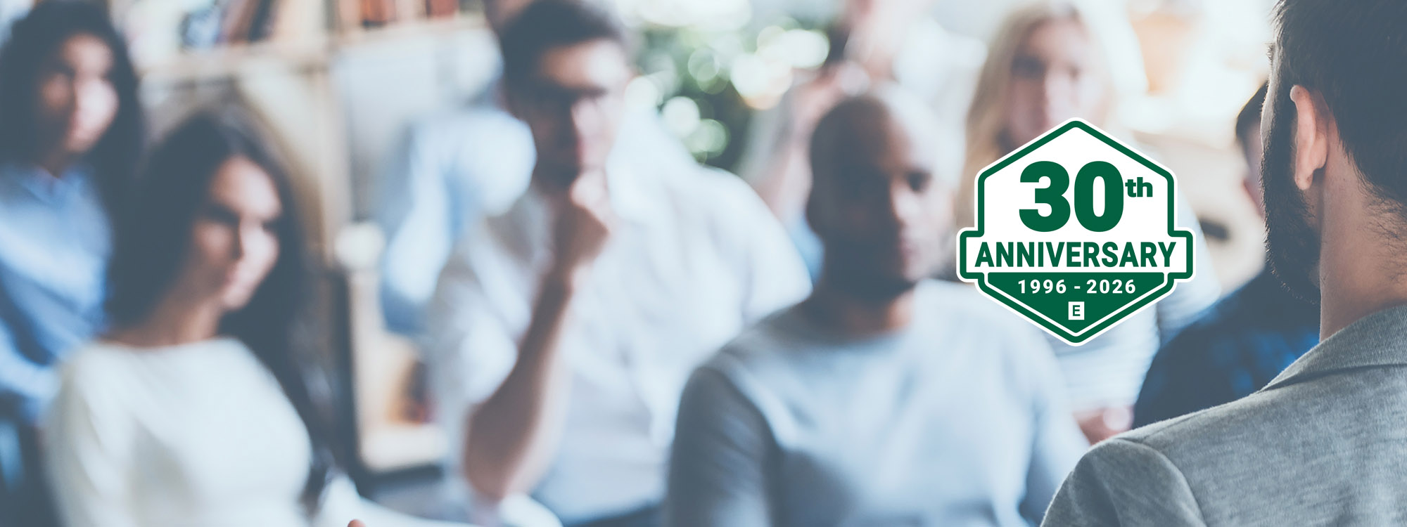 Backshot of man facing seated audience